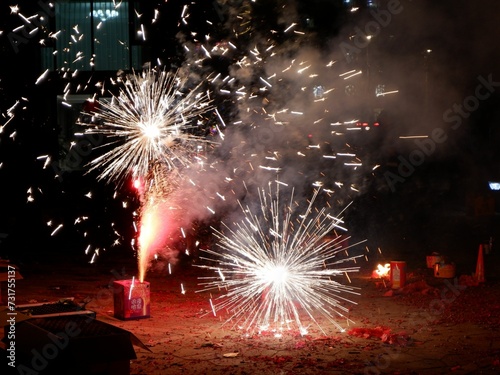 large fireworks being fired in the air over a dirt ground photo
