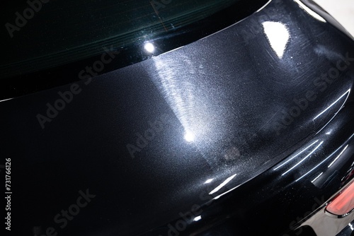 Before and after effect polishing car body varnish in car detailing studio photo