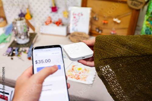 Paying for items at small side hustle business with square payment terminal photo