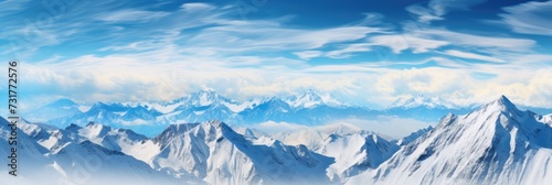 Landscape of a winter mountain range covered in snow with a bright blue sky. © brillianata
