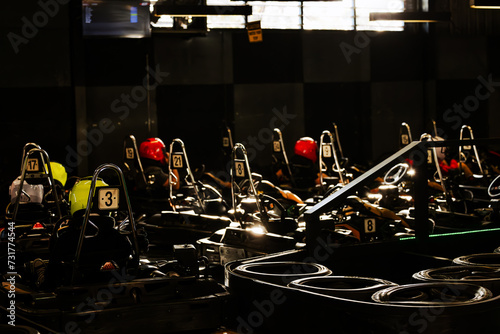 Racers sitting in Go Karts ready to start racing on indoor circuit track photo