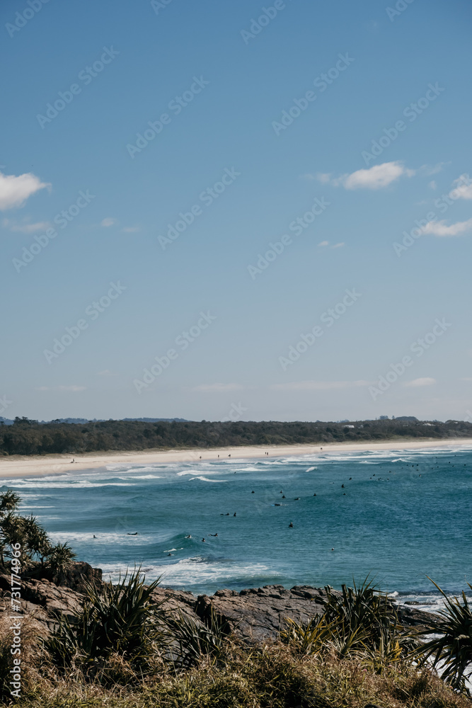 Long stretch of beach dotted with surfers. Long stretch of beach dotted with surfers.