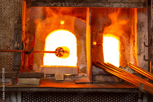 Glass master working in front of the furnace in Murano Island in Venice Italy