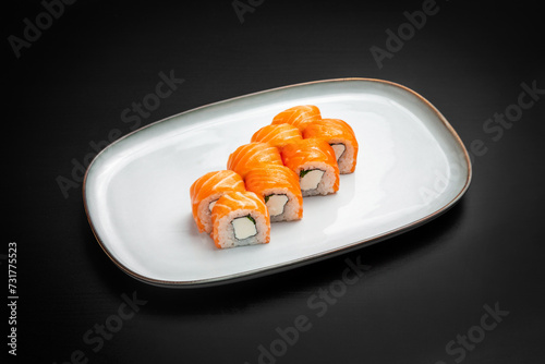 Sushi, Philadelphia rolls with onions. On a black background.