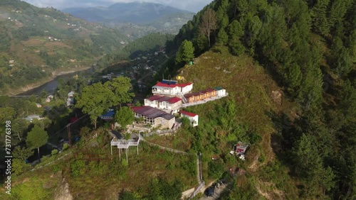 Rotating drone over cottages on a green forest mountain in Mussoorie,Uttarakhand, India photo