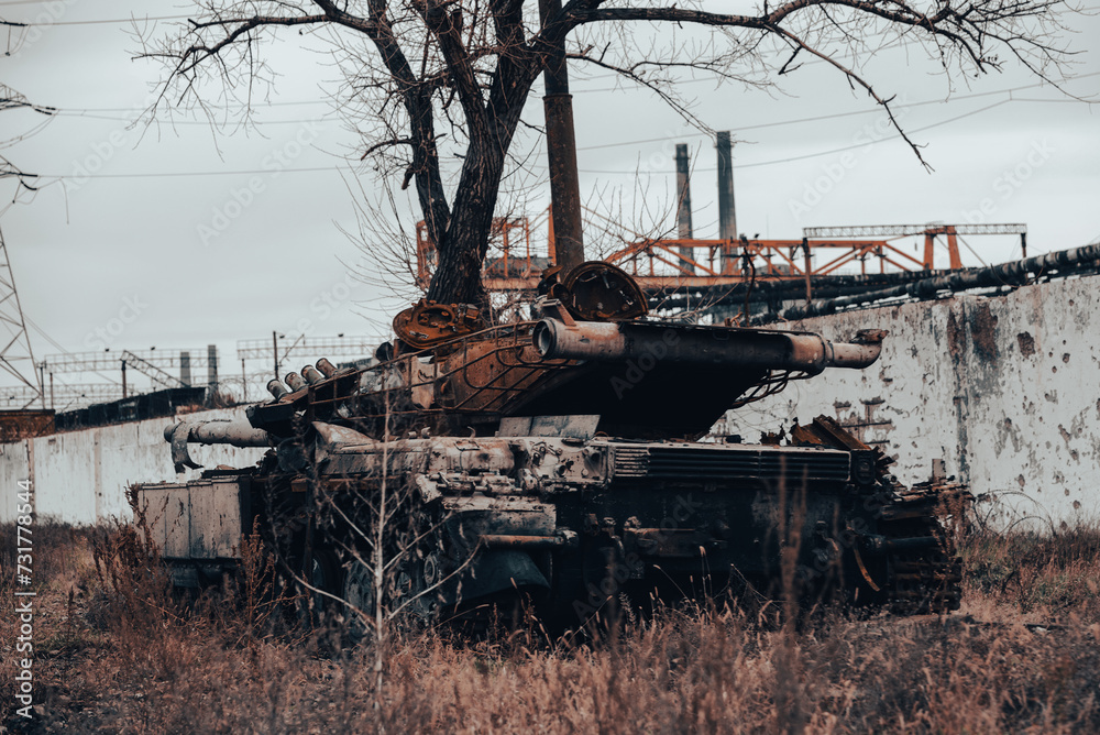 Fototapeta premium burnt tank and destroyed buildings of the Azovstal plant shop in Mariupol