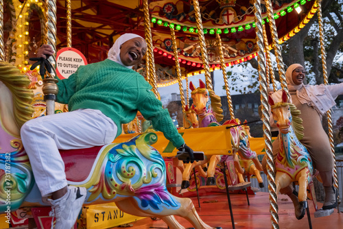 Valokuva Young female tourists in hijabs on merry-go-round