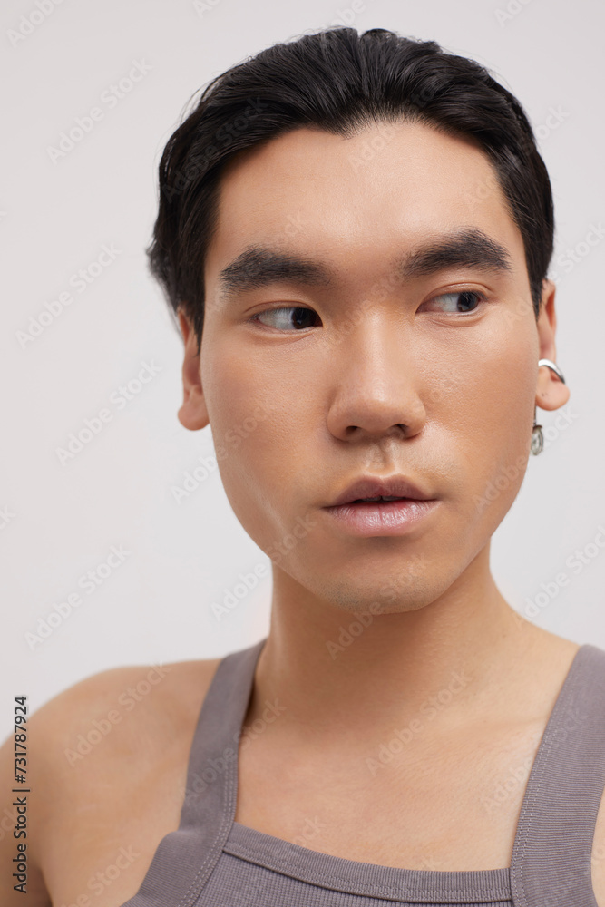 Studio portrait of handsome man with ear piercing