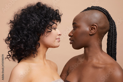 Studio portrait of beautiful women standing face to face