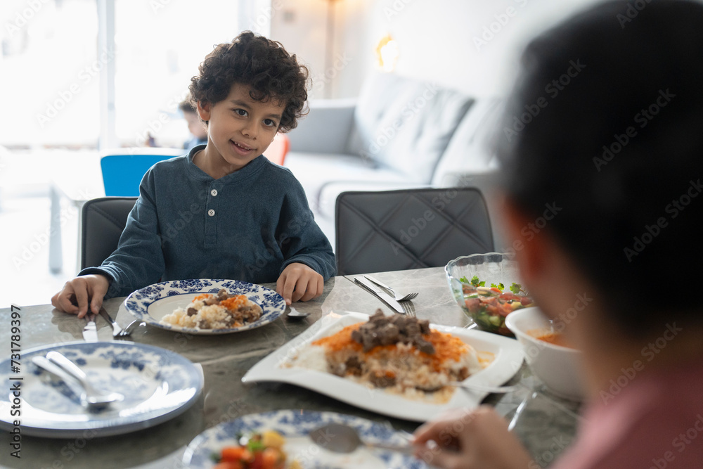 Boy (6-7) eating meal with mother at home Boy (6-7) eating meal with mother at home