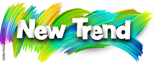 New trend paper word sign with colorful spectrum paint brush strokes over white.