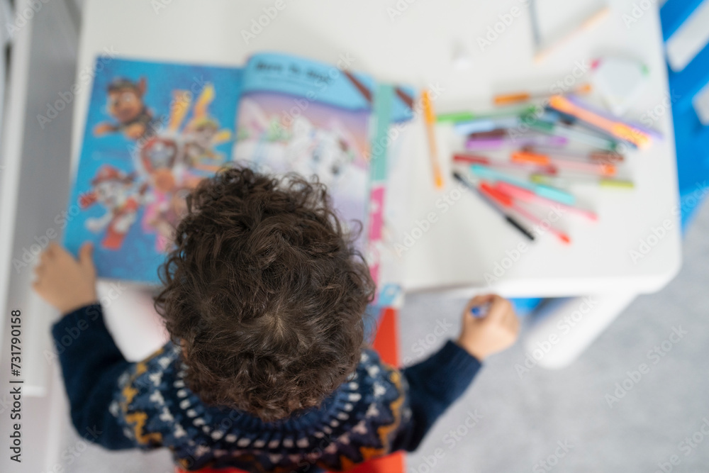Overhead view of boy (2-3) coloring in coloring book at home Overhead view of boy (2-3) coloring in coloring book at home
