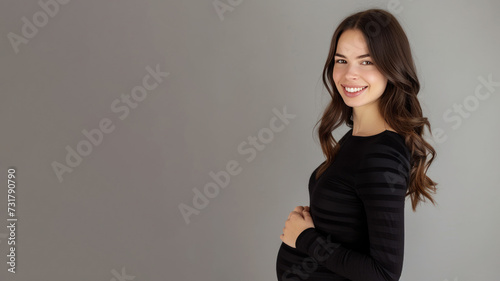 Brunette pregnant woman with pregnancy belly, in soft black clothes © pariketan