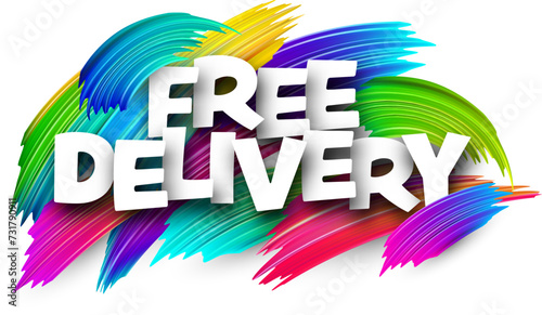 Free delivery paper word sign with colorful spectrum paint brush strokes over white.