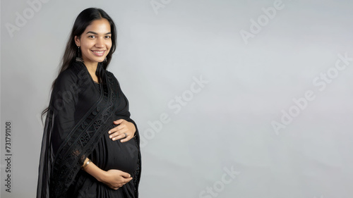 Indian pregnant woman with pregnancy belly, in soft black clothes