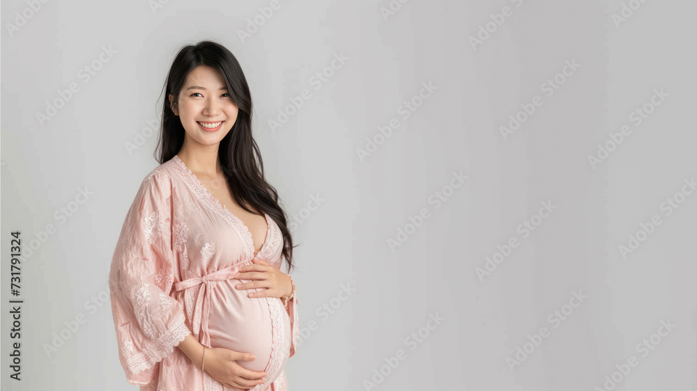 Asian pregnant woman with pregnancy belly, in soft pink clothes Asian pregnant woman with pregnancy belly, in soft pink clothes