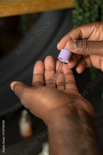 Man applying beauty product on hand with pipette