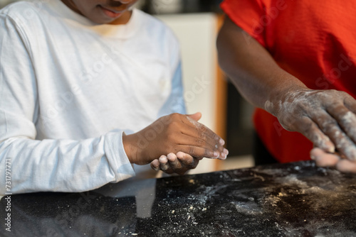 Boy with grandmother baking in kitchen