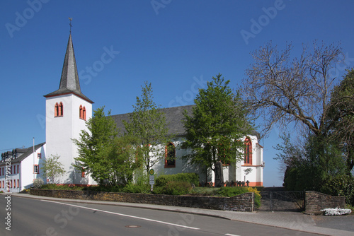 Gothic St. Luzia church with white bell tower in Habscheid village, Eifel region in Germany