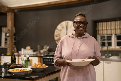 Senior woman serving dinner