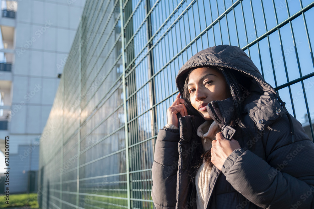 Ταπετσαρία Portrait of woman in overcoat with hood leaning at fence