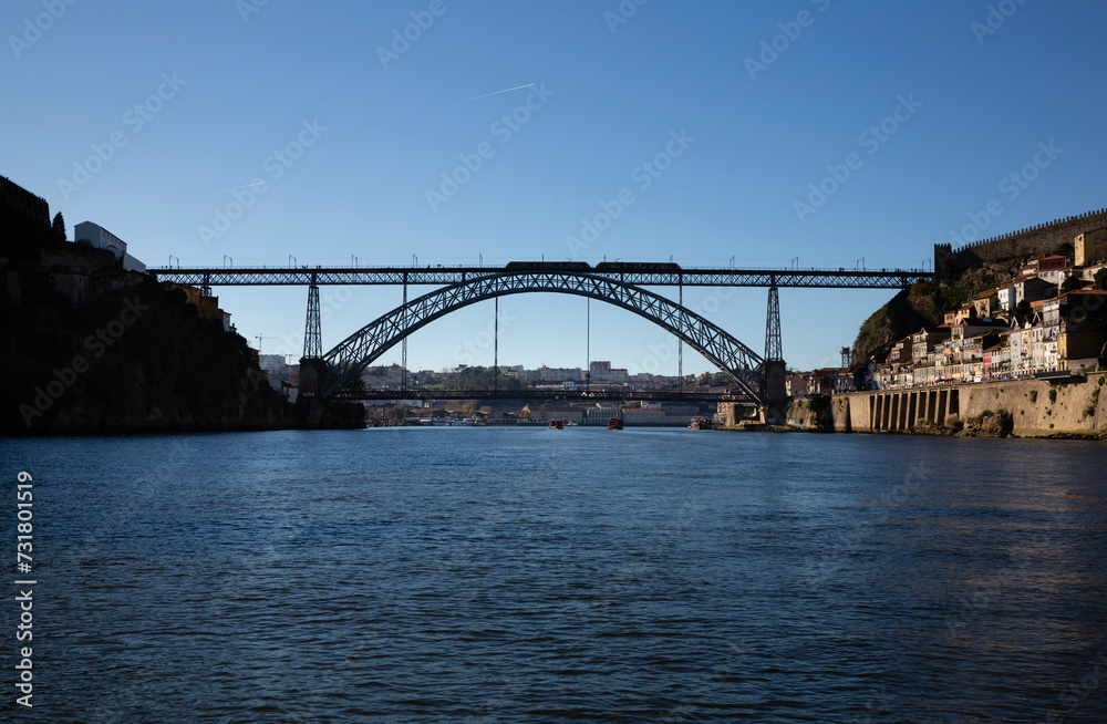 View of the Luis I Bridge, Muralha Fernandina and Gustavo Eiffel Avenue in O Porto on a sunny day with blue sky