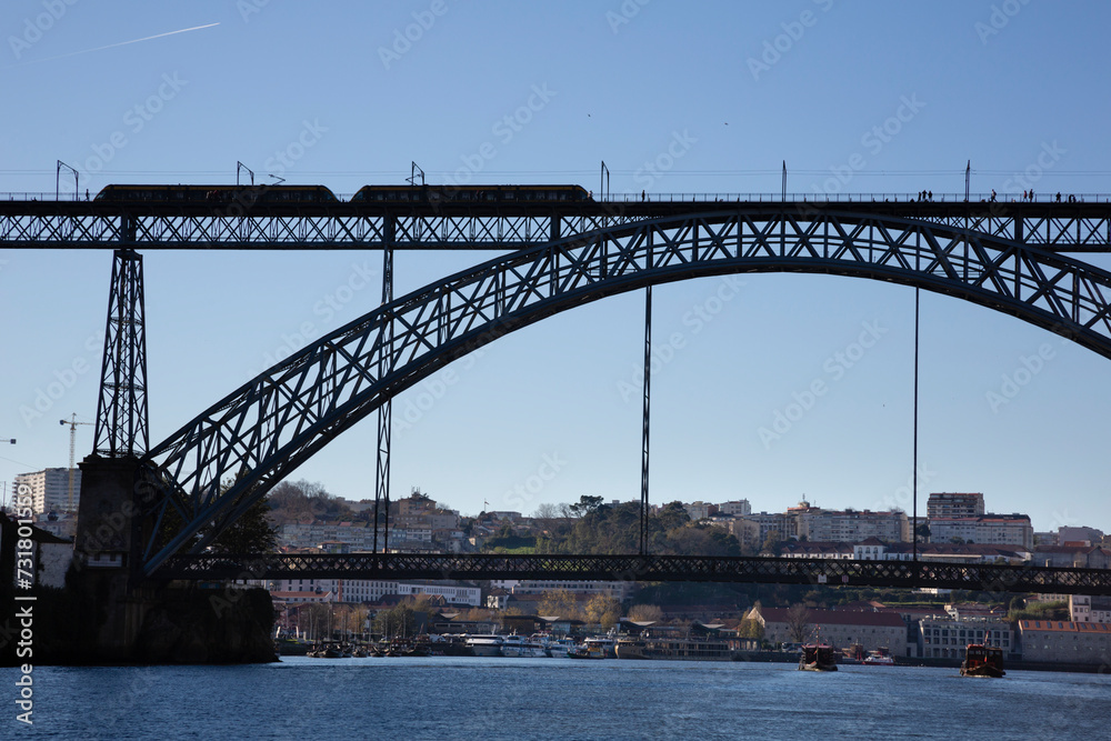 View of the Luis I Bridge, Muralha Fernandina and Gustavo Eiffel Avenue in O Porto on a sunny day with blue sky