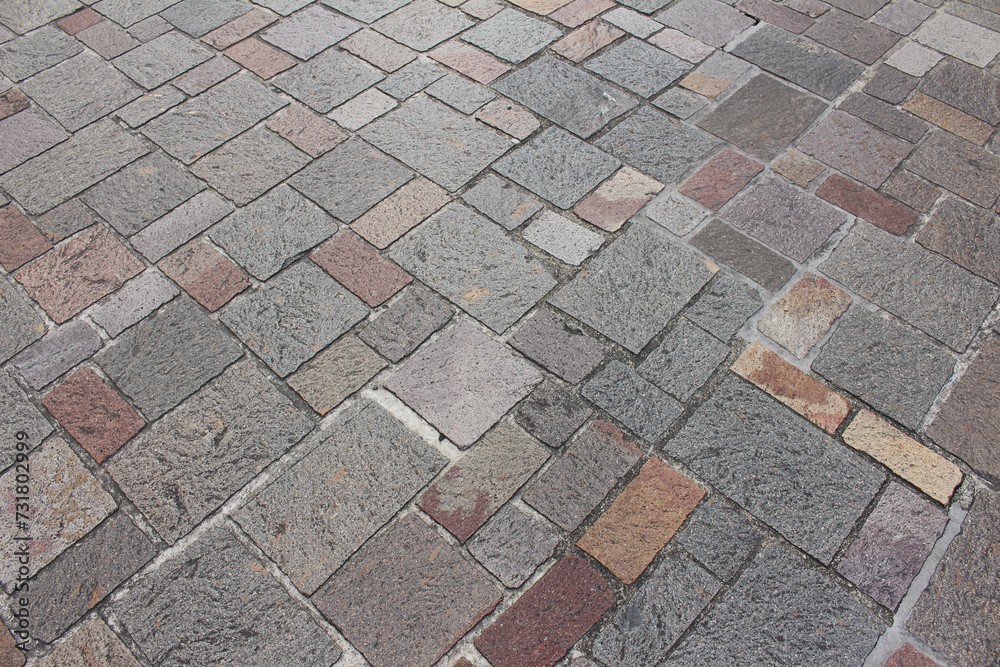 Texture of combination of different size square cobblestones. Pattern of sidewalk tiles in the street. Texture of combination of different size square cobblestones. Pattern of sidewalk tiles in the street.