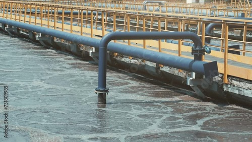 Process of purification effluent water flowing in outdoor channels at wastewater treatment plant facility.