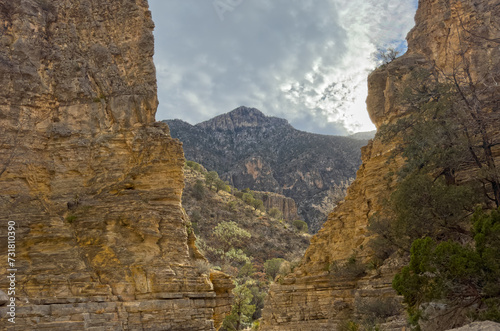 A cloudy sky landscape over the desert in Texas looking through a canyon and mountains in Guadalupe Mountains National Park USA.