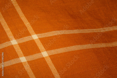 A beautiful sharp orange color Kain Pelikat or Kain Sarong with stripe forming a square shape. A traditional fabrics from Malaysia.
 photo