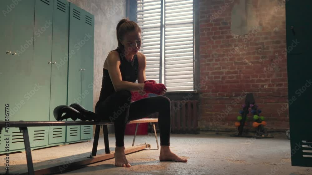 Confidence young woman fighter boxer wraps hands wrists with boxing ...