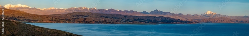 Panoramic view of the Cordillera Real mountains from the shores of the Titicaca Lake, Bolivia. The Potosi peak is prominent on the right