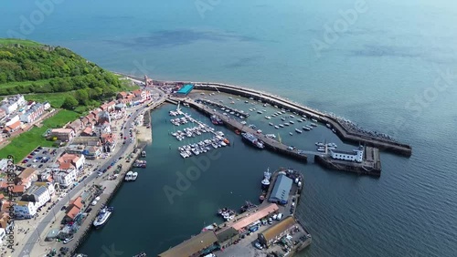 Drone view over a harbor on a seacoast with residential buildings photo