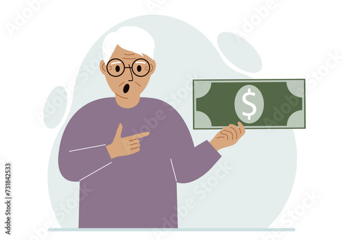 A old man holds a large paper bill in his hand. The concept of income, expense, earning or spending money.