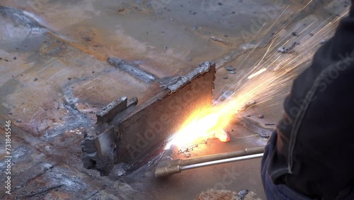 Detail of steel cutting with propane oxygen gas blowtorch burner photo