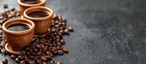 Three cups of coffee sit atop a mound of coffee beans, creating a tempting scene for coffee enthusiasts. photo
