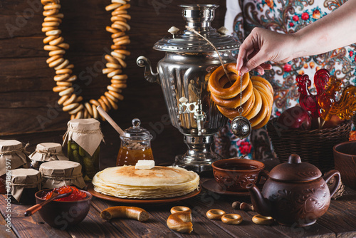 Tea party with pancakes, samovar tea and pickles photo
