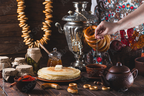 Tea party with pancakes, samovar tea and pickles photo