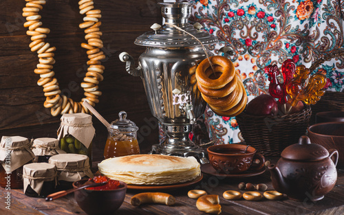 Tea party with pancakes, samovar tea and pickles photo