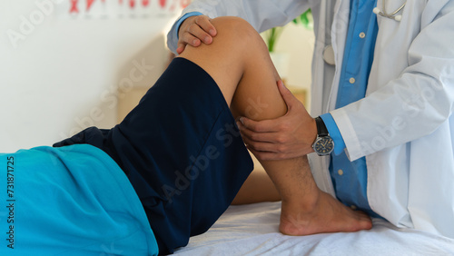 Photography Male doctor  in white gown examined the patient with knee pain problem