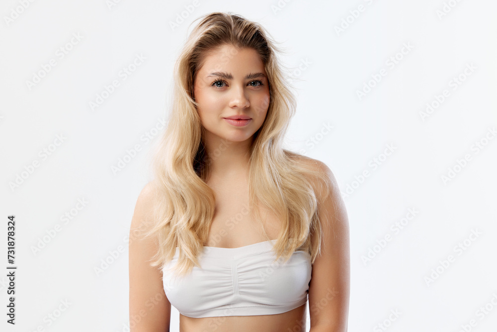 Beauty product advertising featuring model with clear skin and natural makeup to promote skincare items. Beautiful young woman against white background. Concept of beauty, cosmetics and cosmetology Beauty product advertising featuring model with clear skin and natural makeup to promote skincare items. Beautiful young woman against white background. Concept of beauty, cosmetics and cosmetology
