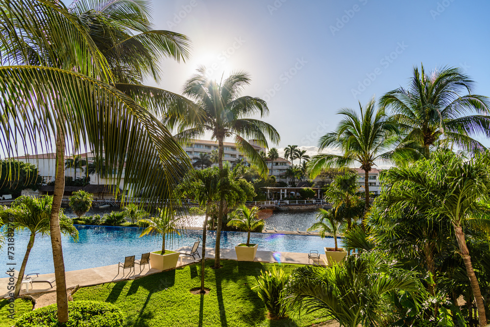 Fototapeta premium View of Palm Trees and Pool in Morning in Mexico