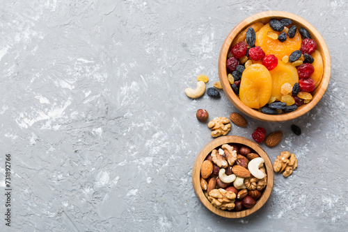 healthy snack: mixed nuts and dried fruits in bowl on table background, almond, pineapple, cranberry, cherry, apricot, cashew