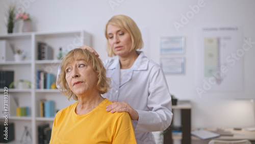 Wallpaper Mural A rehabilitation specialist examines a senior patient's neck sprain, focusing on diagnostics Torontodigital.ca