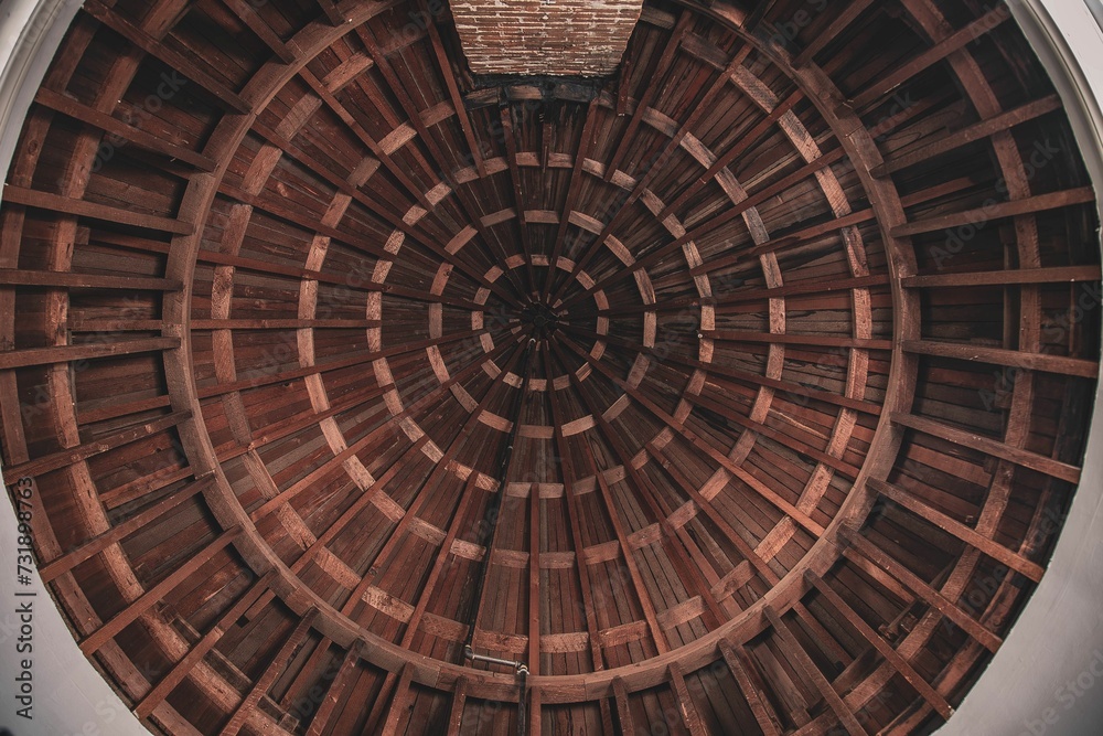 A low angle shot of a circular wooden roof