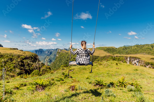 Hiker woman on a swing in Canyon park in Santa Catarina, Brazil. photo