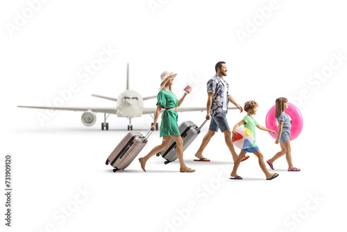 Family boarding a plane for a summer vacation, packed with suitcases and beach accessories photo