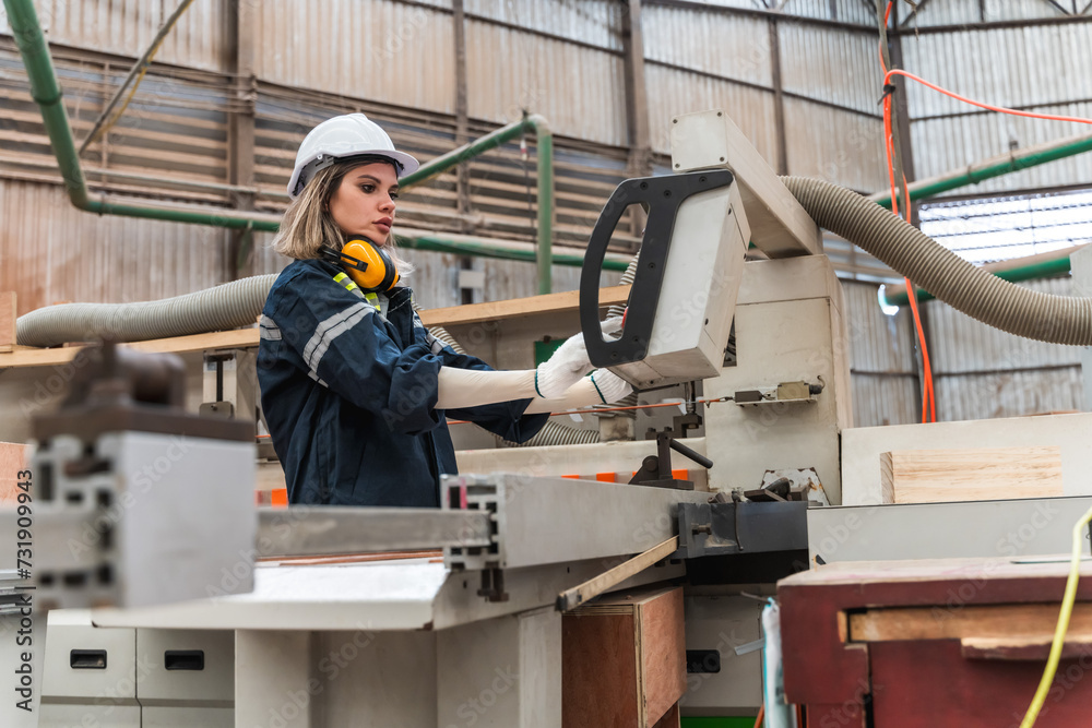 Factory female worker working with control machine in wood production line in wood factory Factory female worker working with control machine in wood production line in wood factory