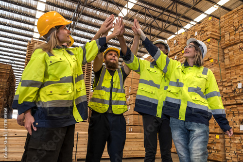 Group of cheerful diversity wood factory worker men and women feeling happy in wood distribution workplace